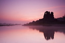 Sunrise over Ogmore Castle on a calm misty spring morning