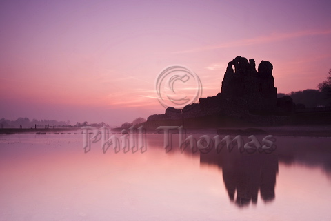 Sunrise over Ogmore Castle on a calm misty spring morning