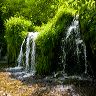 Water cascades through the vegetation at Lathkill Dale